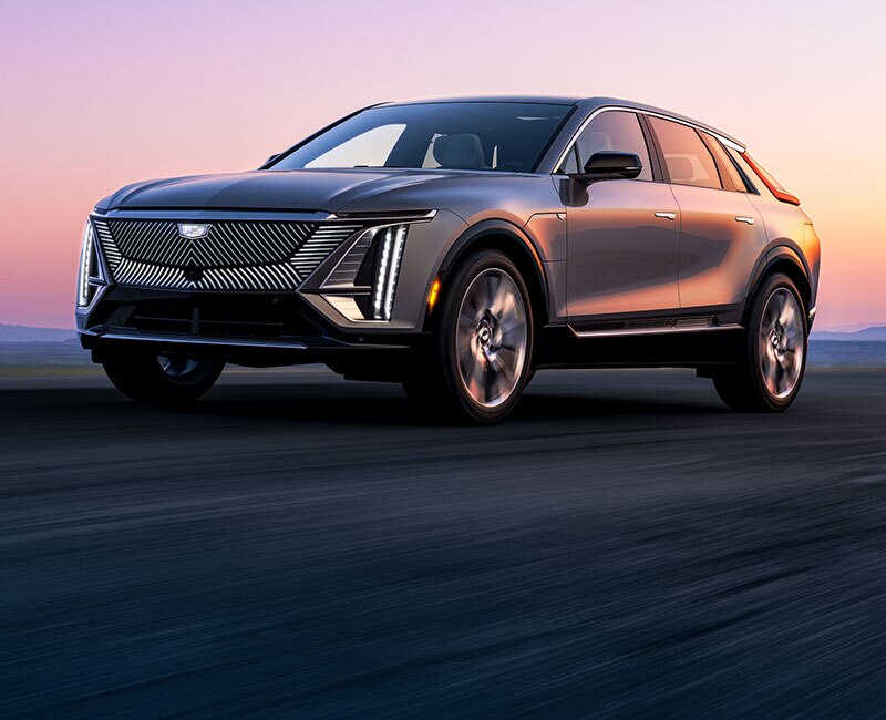 Cadillac LYRIQ EV 2023 estacionada, con el atardecer de fondo