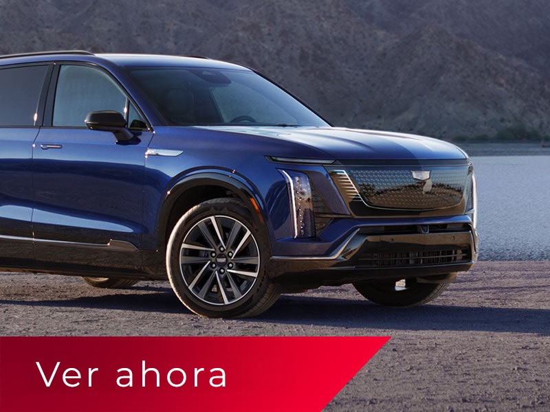 Vista de medio perfil de una Cadillac VISTIQ 2027 en Azul estacionada sobre una superficie de asfalto con vista a las montañas